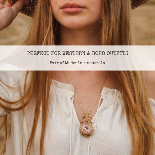 Peach druzy quartz geode necklace worn with flowy white blouse, styled for boho western outfits, gold wire wrapped crystal pendant layered with neutral tones, statement jewelry piece perfect for denim outfits and rustic fashion styling inspiration