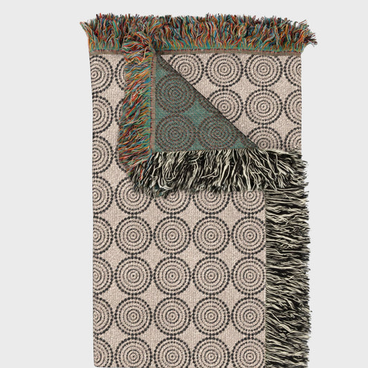 Folded circles woven throw blanket highlighting thickness and fringe detail