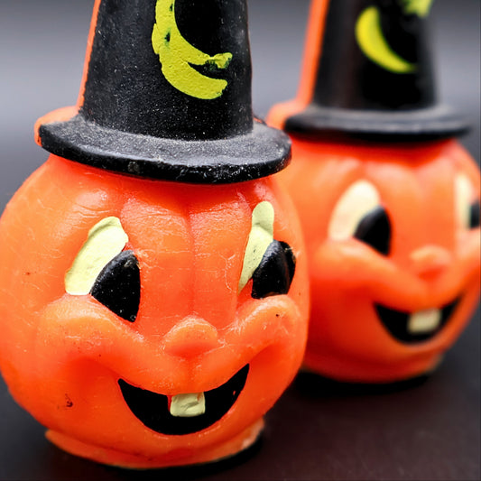 Close up of jack o lantern face on vintage Gurley pumpkin candle with painted eyes and smile