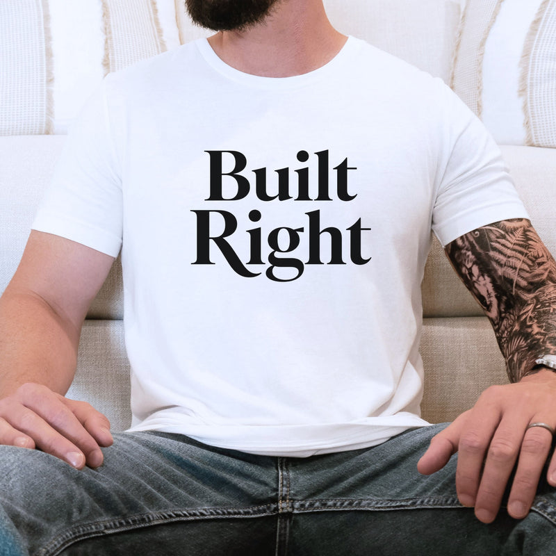 man wearing white t-shirt with Built Right graphic styled with jeans casual men’s essentials outfit simple clean everyday apparel look