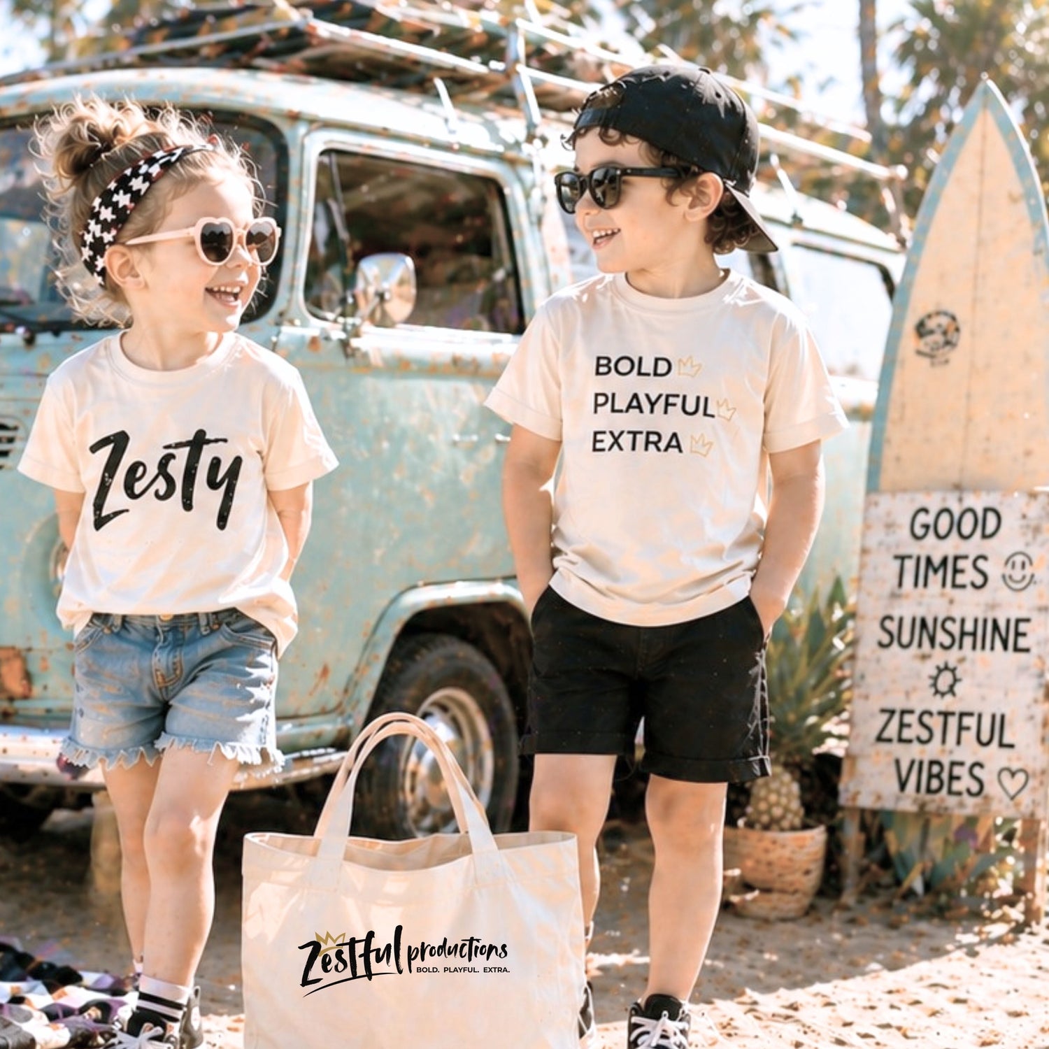 Kids wearing Zesty graphic tees standing by vintage van at beach with tote bag, playful kids clothing and summer outfits for little personalities with big energy