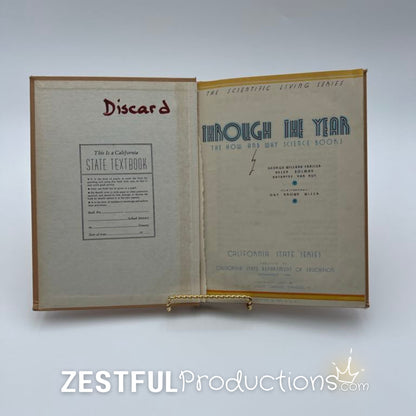 Inside front cover of 1944 Through the Year California State textbook showing discard stamp and title page
