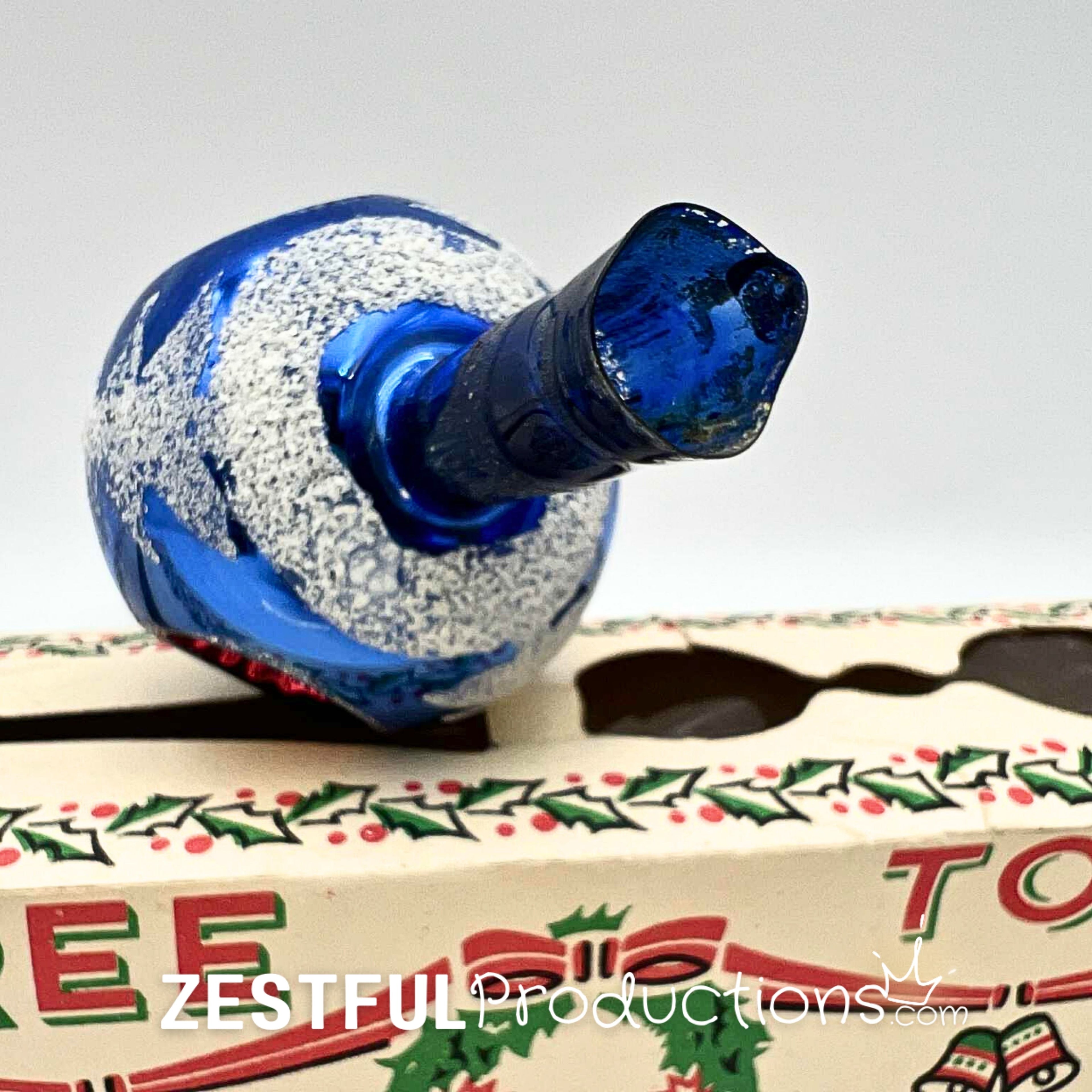 Bottom opening detail of vintage mercury glass Christmas tree topper showing blue handblown glass construction and authentic mid century holiday ornament craftsmanship from the 1960s.