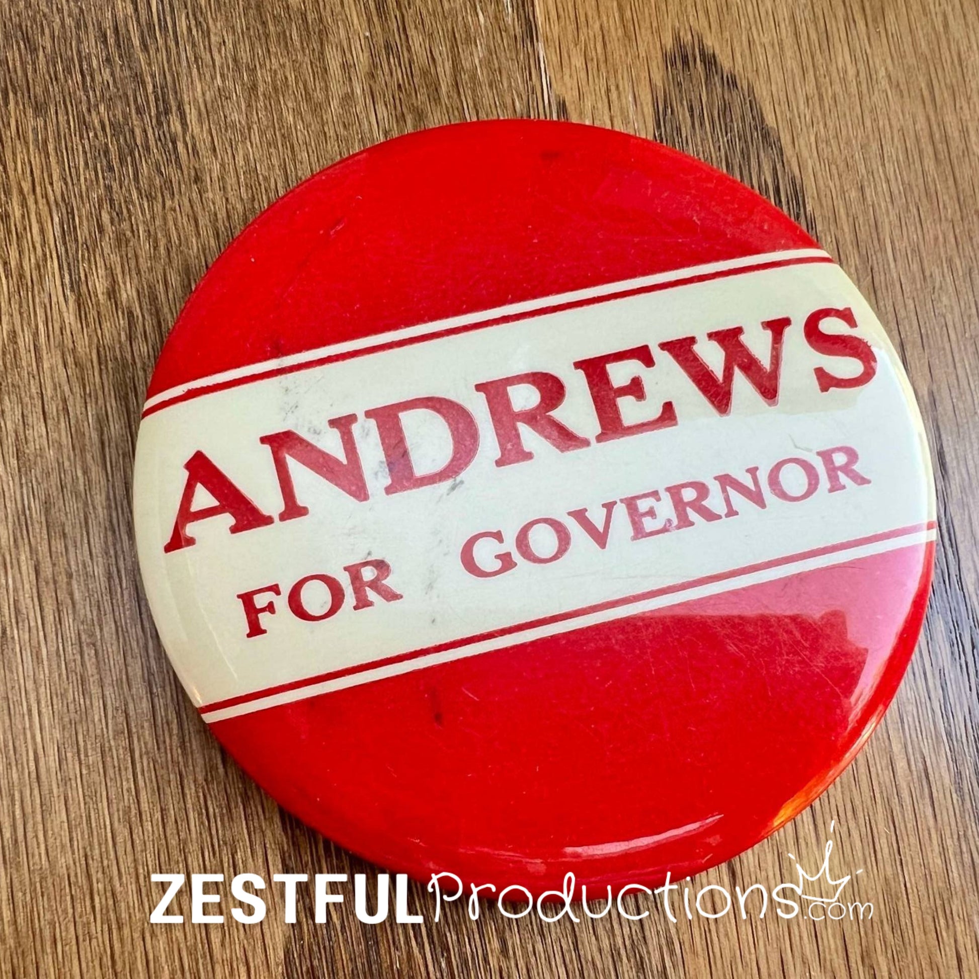Vintage 1962 North Dakota “Andrews for Governor” campaign button featuring red and cream diagonal design, 3.5 inch pinback.