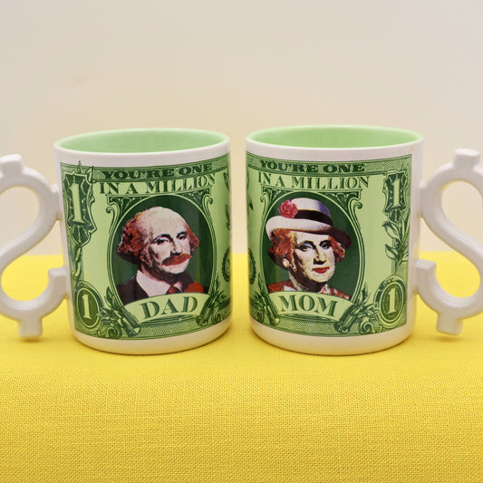 1986 Enesco Mom and Dad vintage coffee mug set with dollar bill design and dollar sign handles
