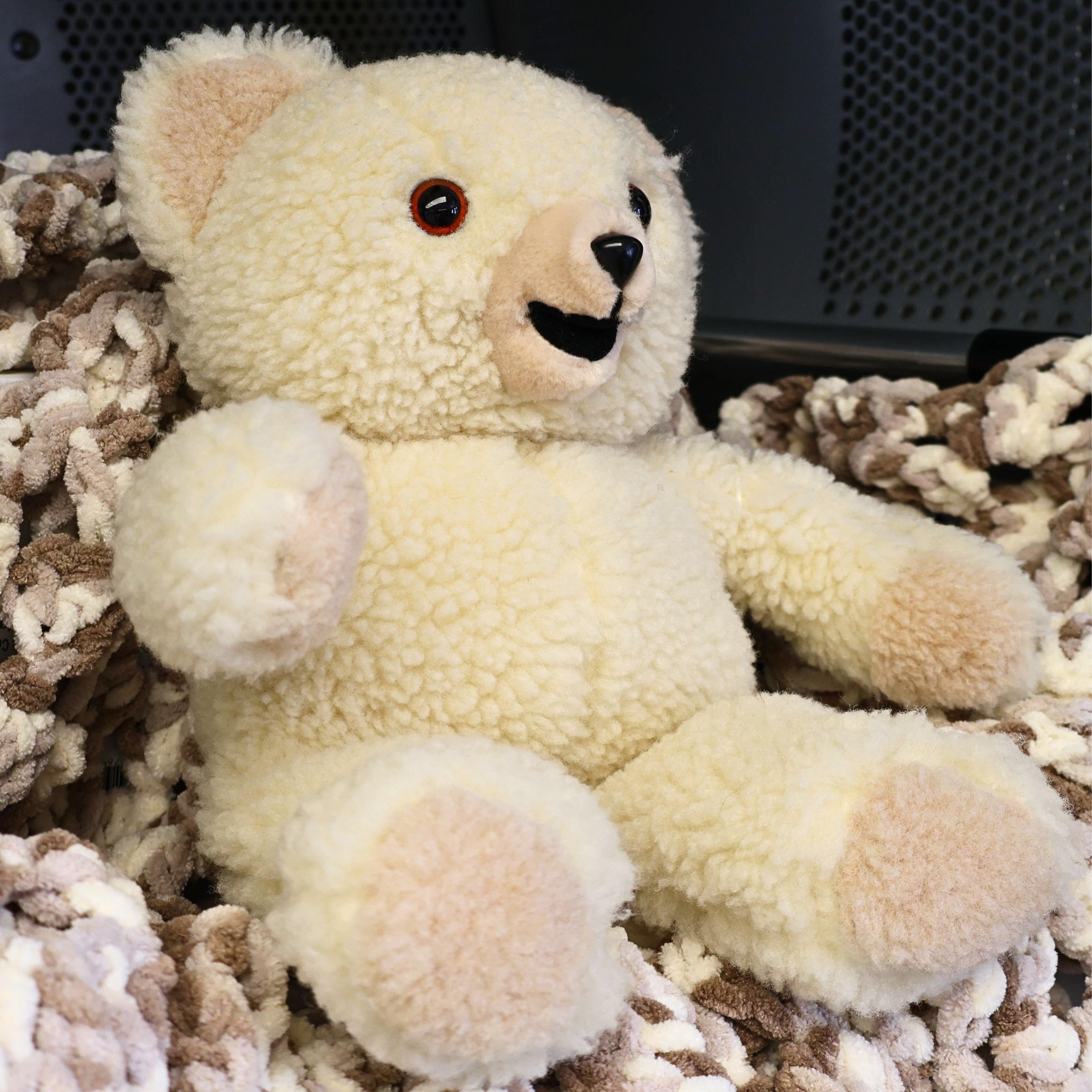 Side profile of a vintage Snuggle Bear by Lever Brothers showing soft sherpa-style plush, rounded ears, beige paw pads, and excellent display quality. This collectible advertising character brings nostalgic 1980s charm to vintage toy collections and home decor.