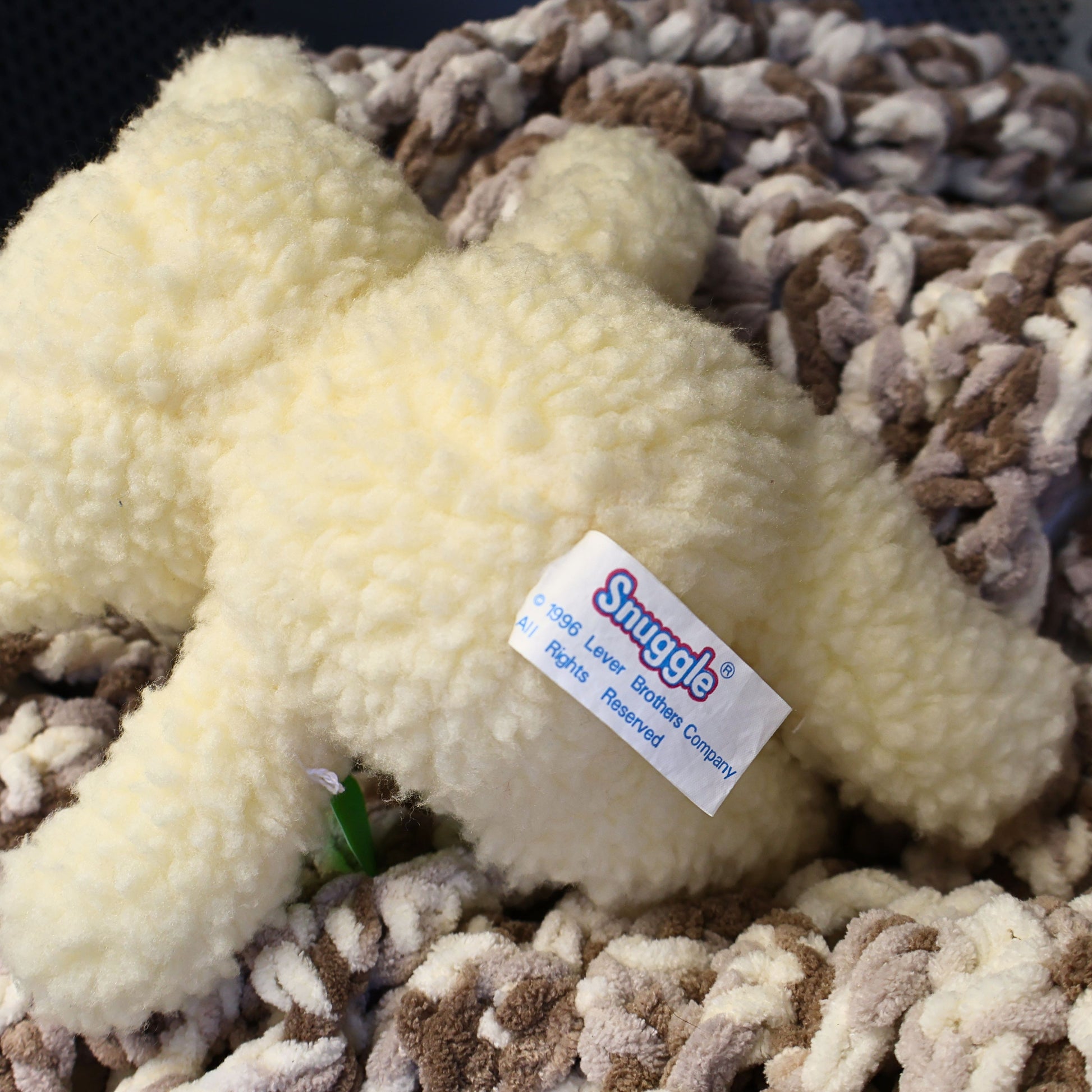 Rear view of the vintage Snuggle Bear plush displaying its original 1996 Lever Brothers copyright tag and full sherpa-style plush construction. An authentic fabric softener advertising collectible ideal for vintage toy collectors and nostalgic shelf displays.