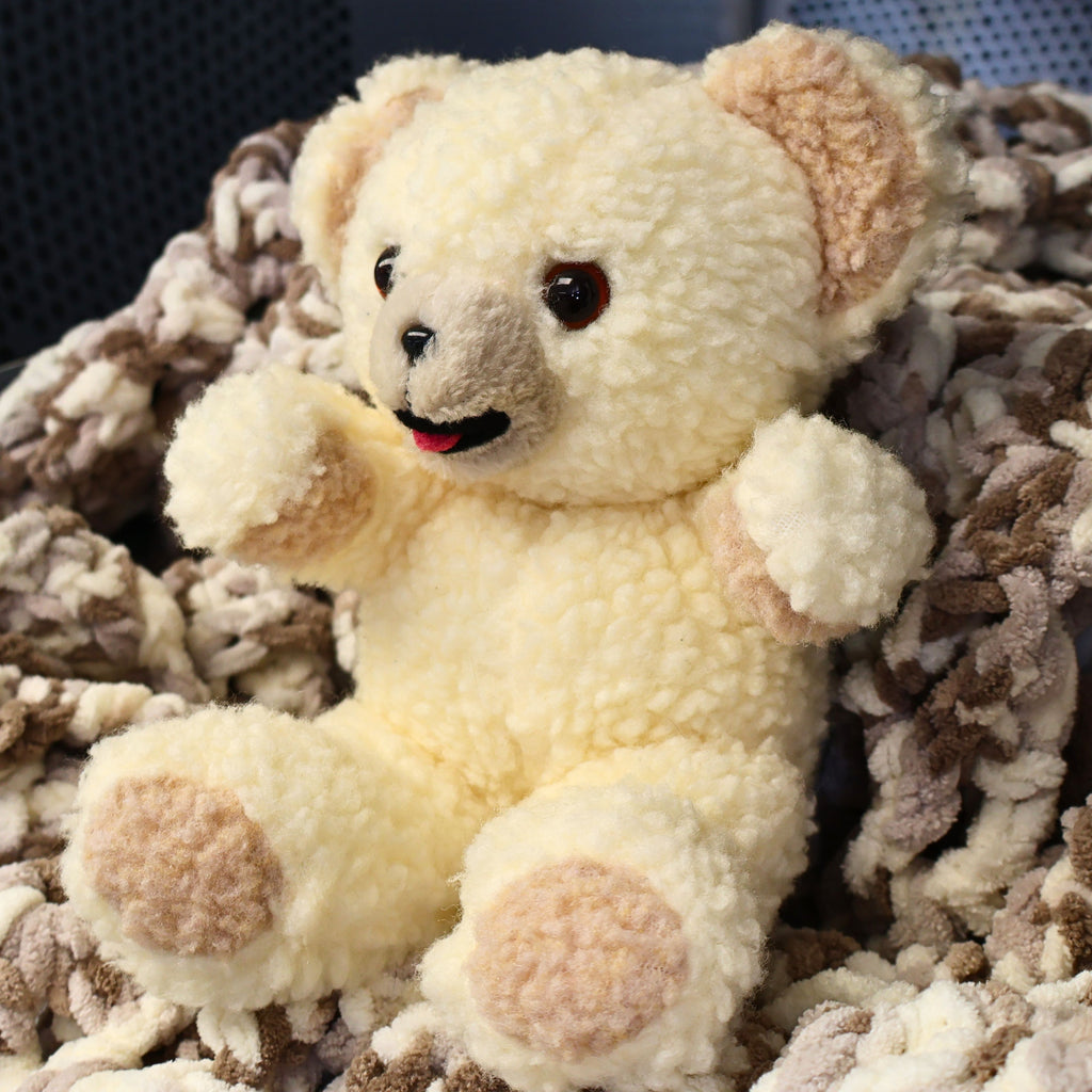 Angled view of an authentic 1997 Snuggle plush by Lever Brothers showing fluffy sherpa texture, embroidered smile, and classic seated pose. A wonderful collectible for vintage advertising enthusiasts, retro toy collectors, nursery shelf decor, or cozy cottage home styling.