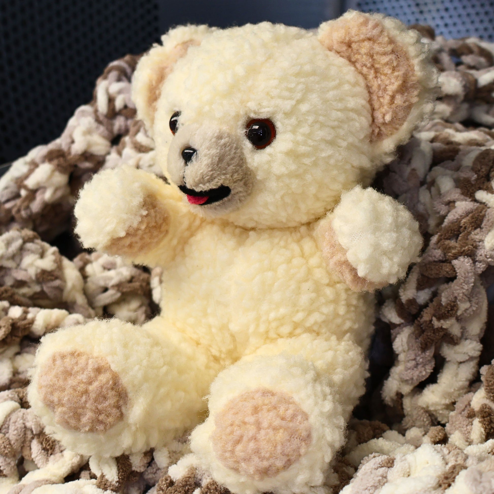 Angled view of an authentic 1997 Snuggle plush by Lever Brothers showing fluffy sherpa texture, embroidered smile, and classic seated pose. A wonderful collectible for vintage advertising enthusiasts, retro toy collectors, nursery shelf decor, or cozy cottage home styling.