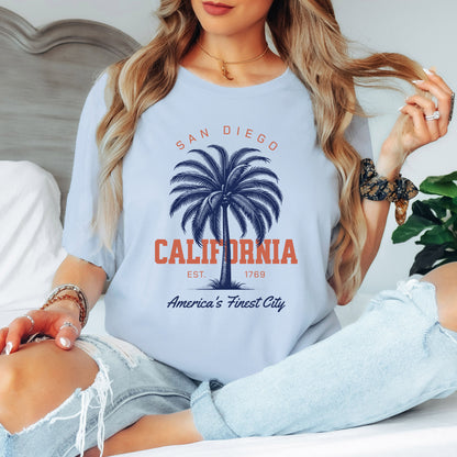 Woman wearing a light blue t-shirt with 'San Diego, California' design.