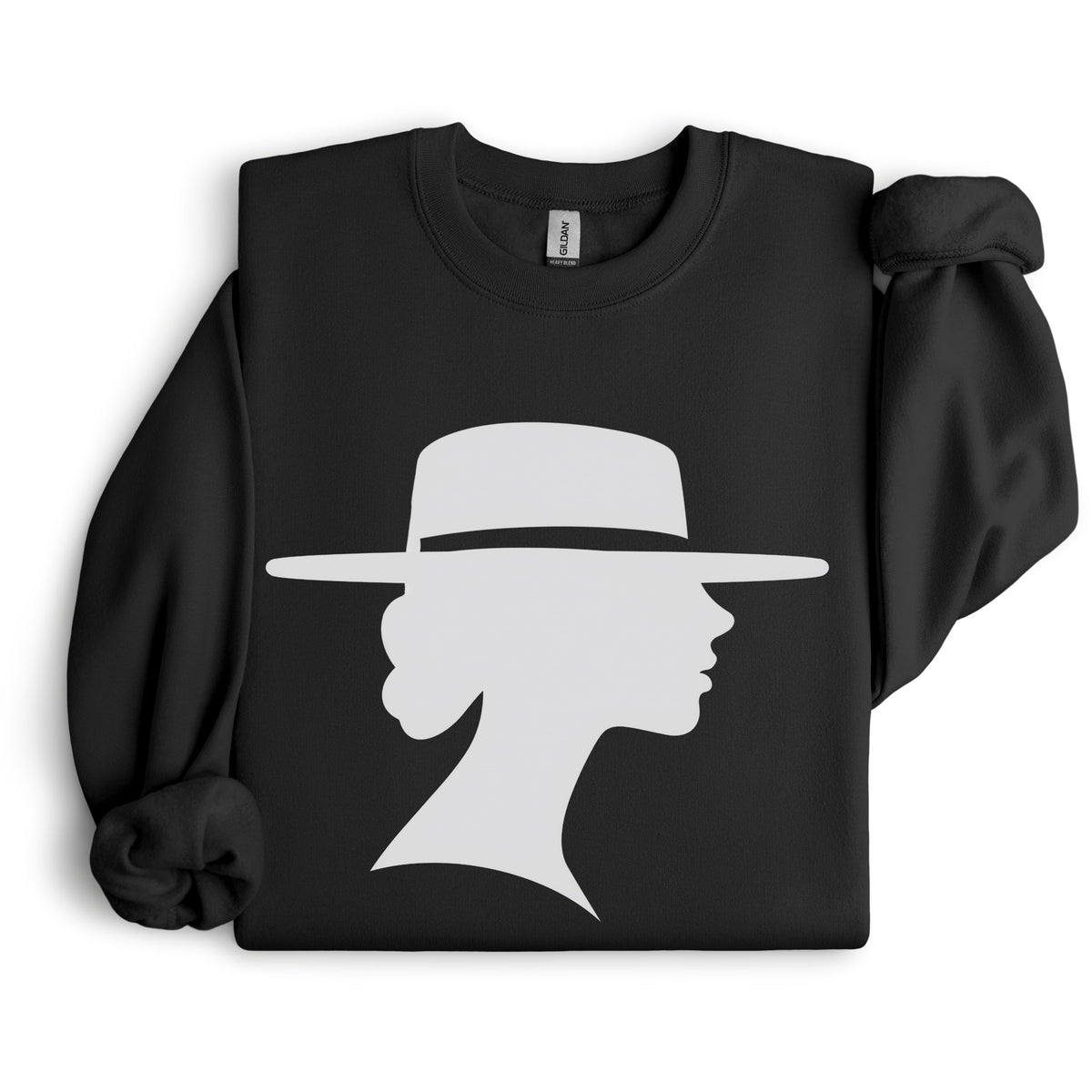 Black crewneck sweatshirt arranged flat with folded sleeves on a white background, featuring a light-colored silhouette of a woman in profile wearing a wide-brimmed hat.
