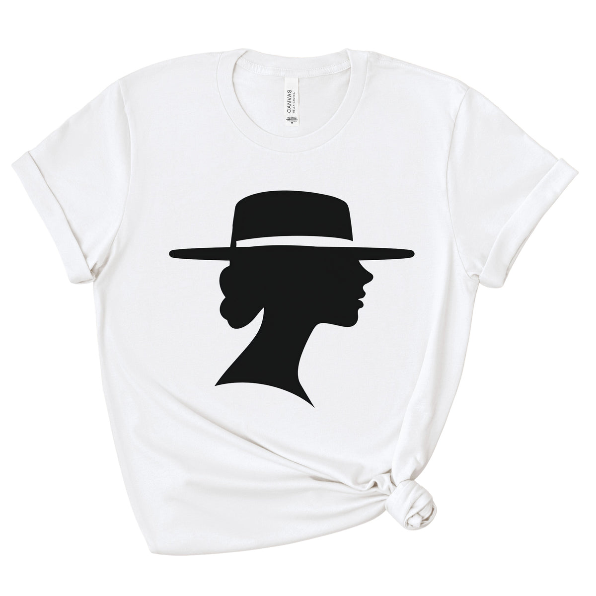 White crewneck graphic tee with rolled sleeves and a knotted hem, shown flat against a white background. A black silhouette depicts a woman in side profile wearing a wide-brimmed hat.