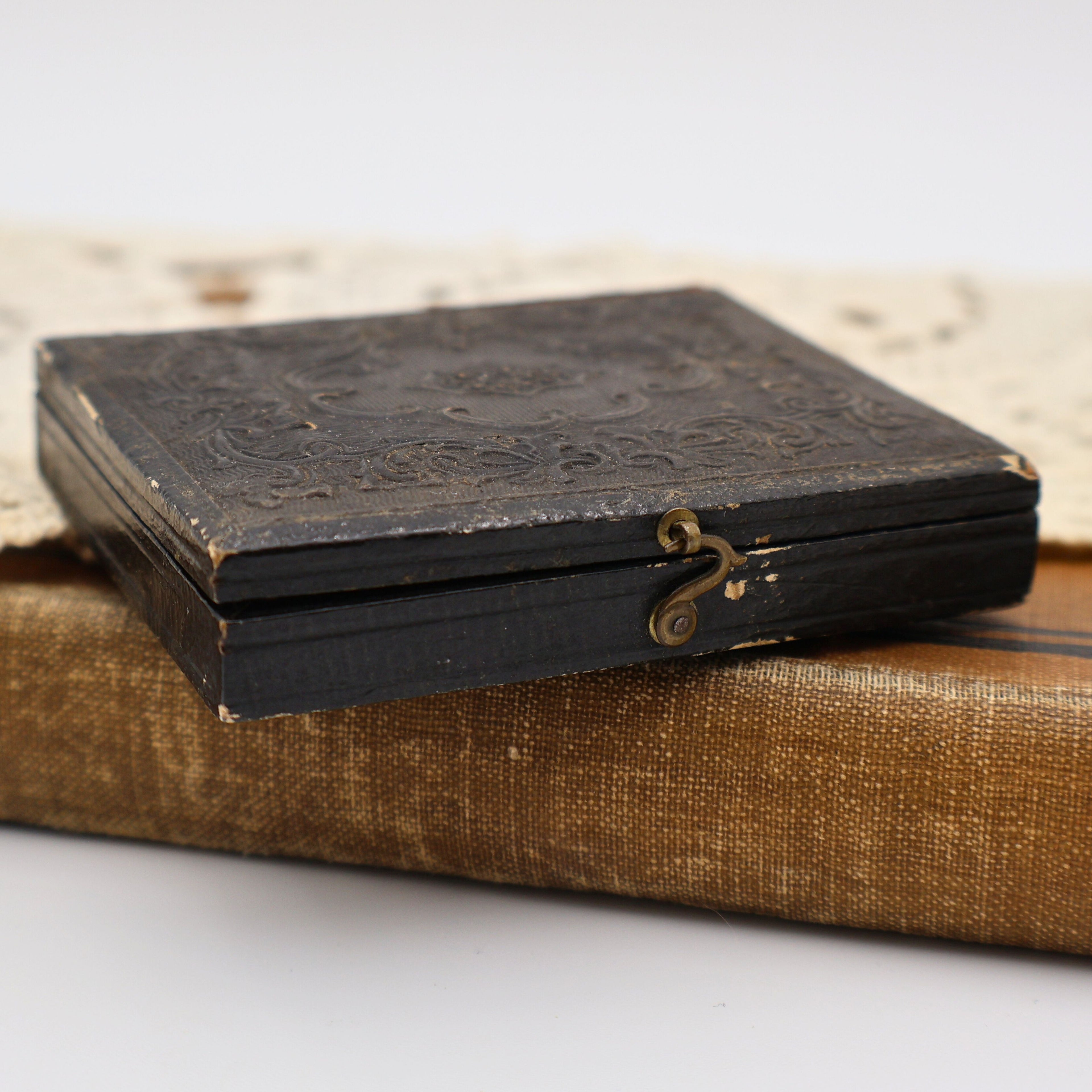 Close view of original clasp and edge wear on antique Civil War era ambrotype case from the 1850s.