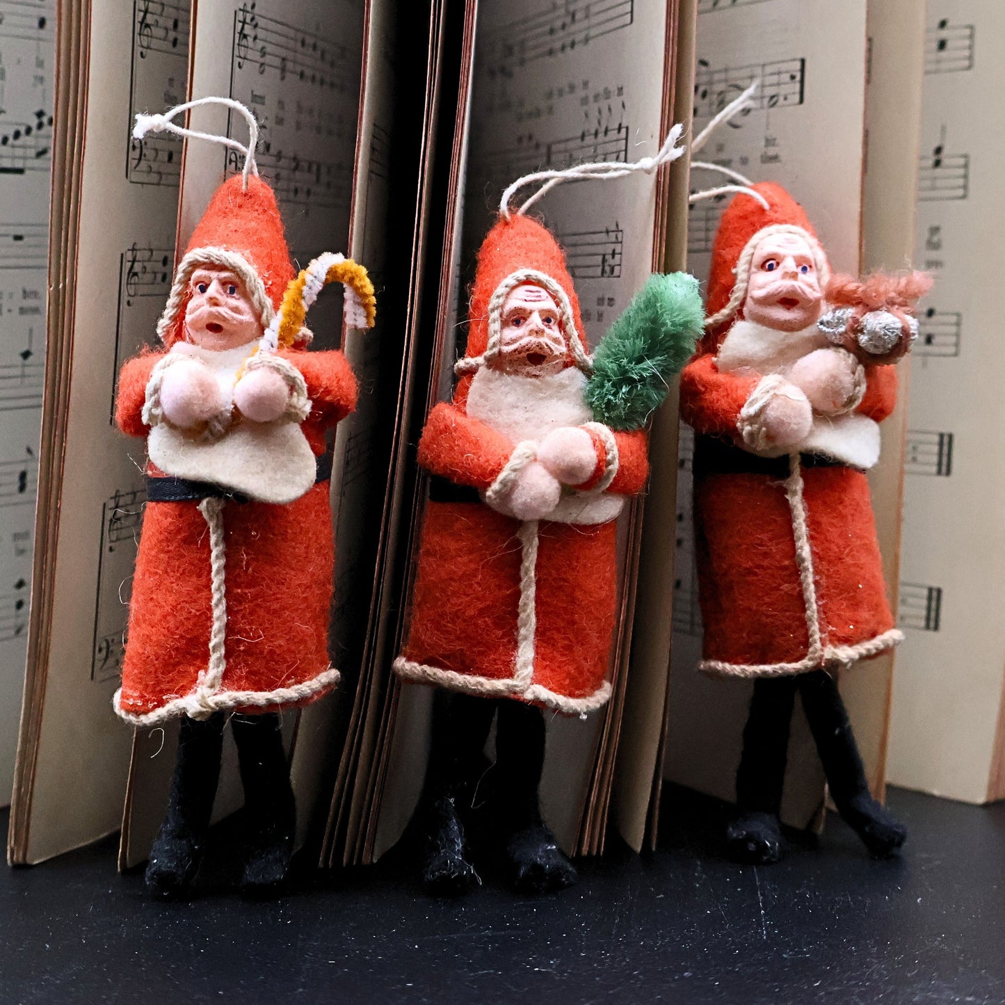 Antique German Belsnickle Santa ornaments hanging display showing original strings and decorative use