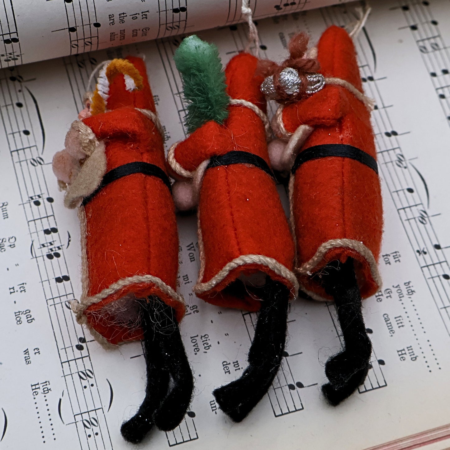 Antique spun cotton Santa ornaments showing back texture and vintage condition with natural wear