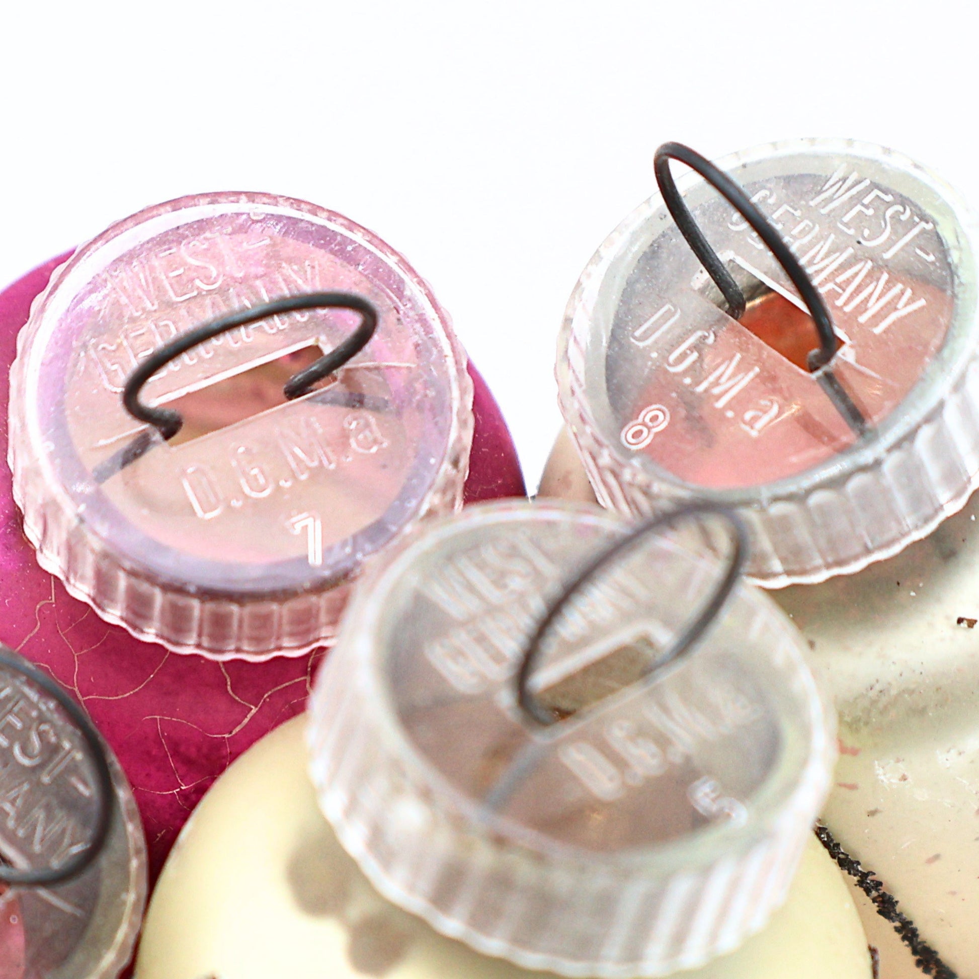 Macro detail of authentic West Germany ornament caps and vintage mercury glass Christmas ornament finishes