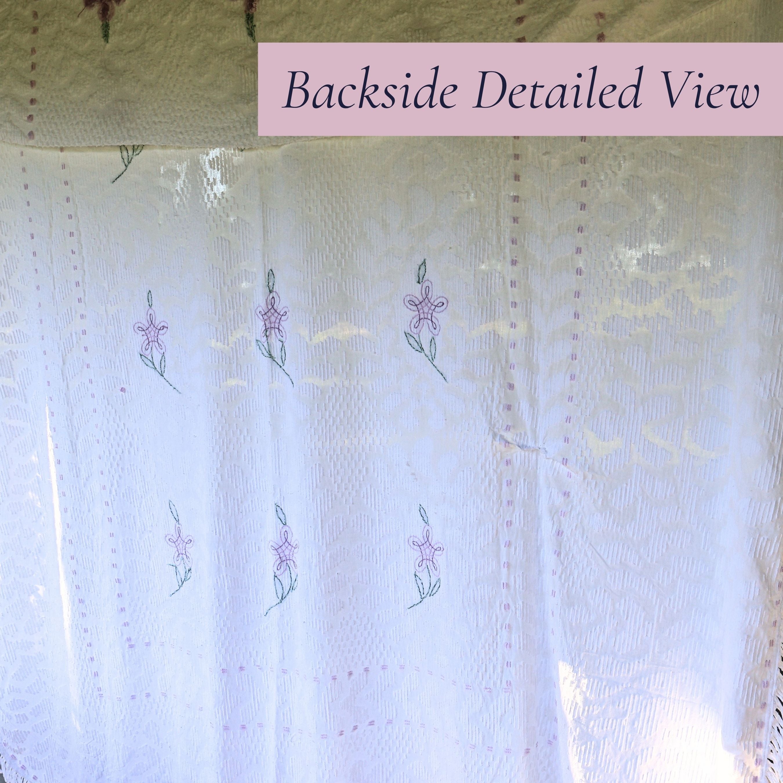 Backlit view of the vintage white chenille bedspread reveals the woven floral pattern, decorative border, and delicate lavender accents. This heirloom textile offers timeless appeal for farmhouse decor, cottage bedrooms, romantic bedding, and vintage home collections.