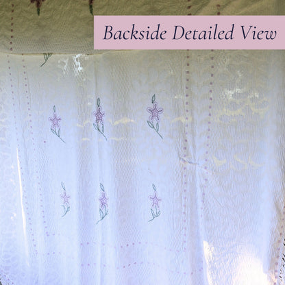 Backlit view of the vintage white chenille bedspread reveals the woven floral pattern, decorative border, and delicate lavender accents. This heirloom textile offers timeless appeal for farmhouse decor, cottage bedrooms, romantic bedding, and vintage home collections.