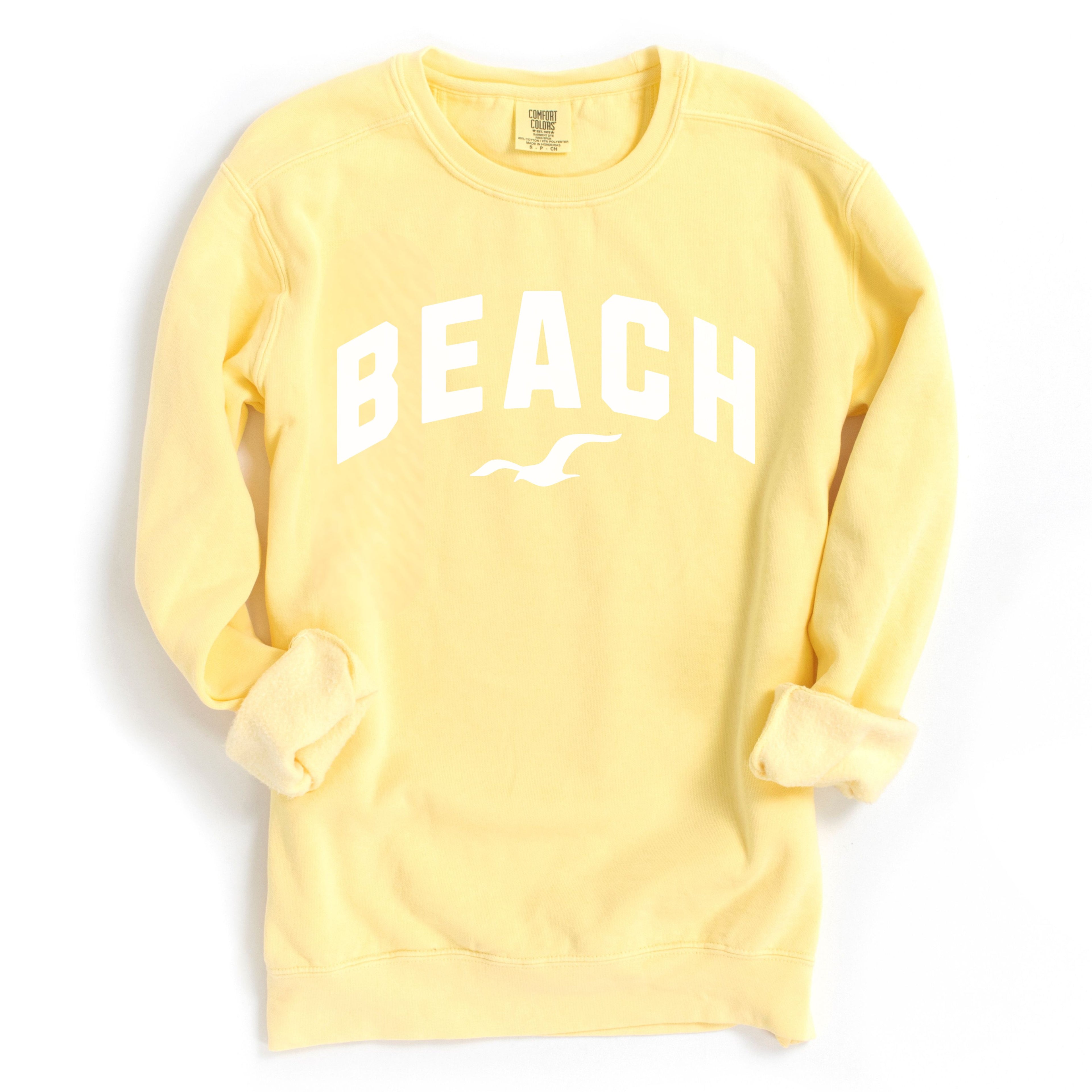 Butter yellow beach crewneck sweatshirt flat lay, oversized fleece pullover with beach graphic, soft cozy cotton blend coastal style sweatshirt for women