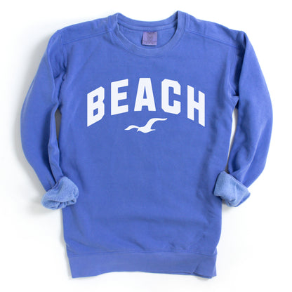 Flo blue beach crewneck sweatshirt flat lay, oversized fleece pullover with beach graphic, vibrant coastal vacation sweatshirt for women