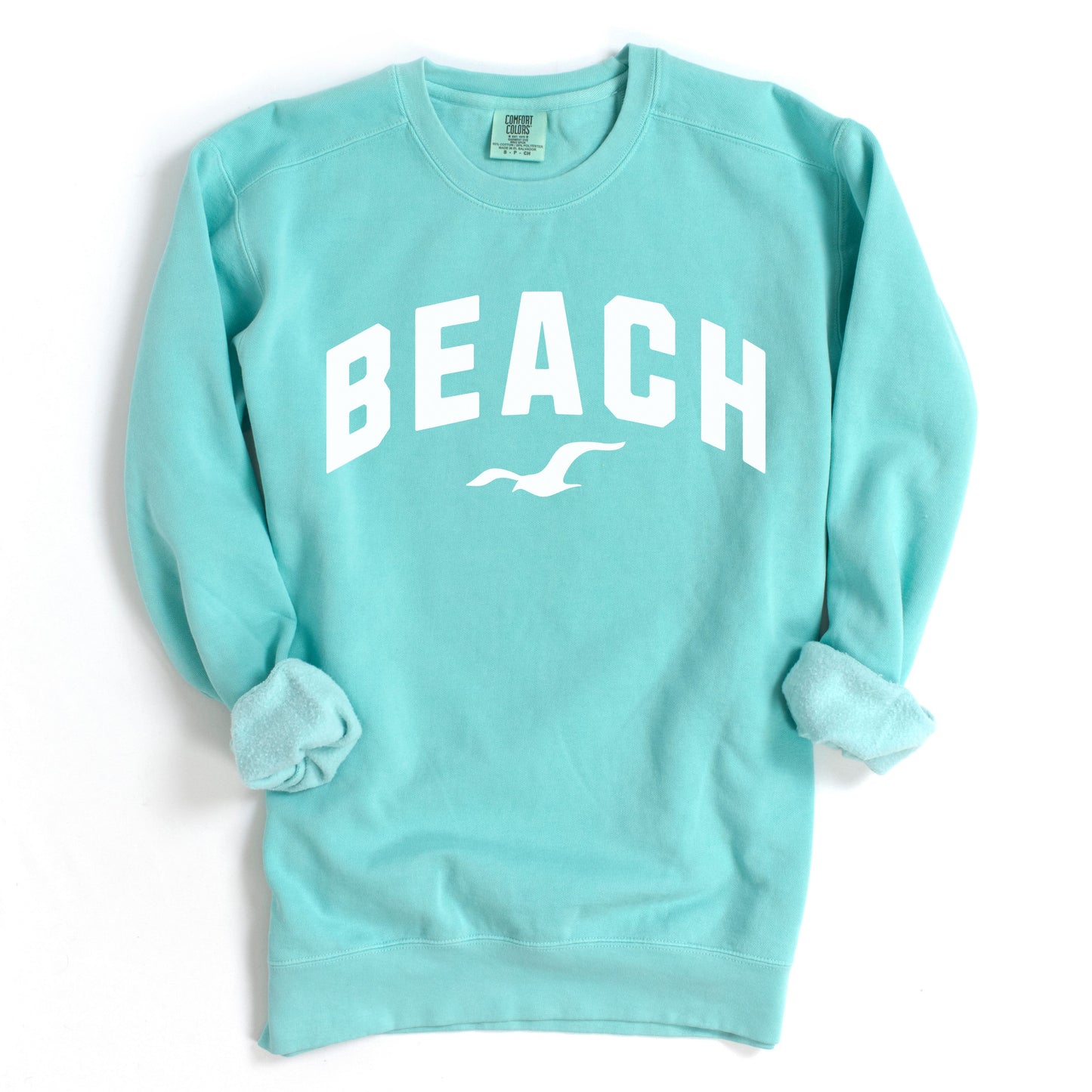 Mint aqua beach crewneck sweatshirt flat lay, relaxed oversized fleece pullover with beach lettering, bright coastal summer sweatshirt for women