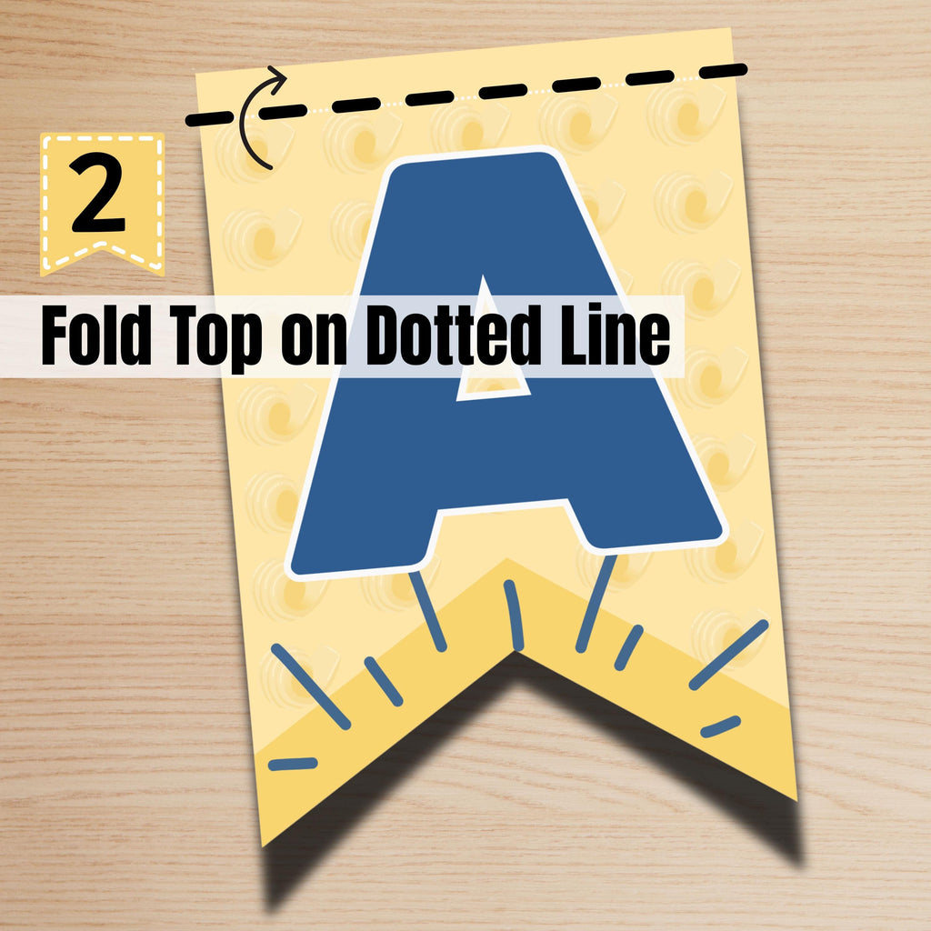 Instruction step showing how to fold butter printable banner pieces along marked lines. Simple DIY party decor process.