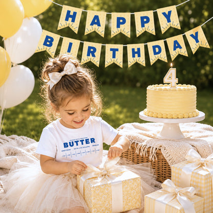 Toddler birthday girl wearing retro butter toddler tee at luxury outdoor birthday picnic with matching butter pennant banner and cake. Boutique foodie kids outfit styled for birthday parties, cake smash photos, and playful celebrations.