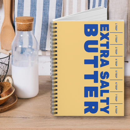 Close up of butter notebook cover with bold lettering and playful design. Spiral bound journal for writing, planning, and creative use.