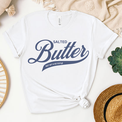 White butter script graphic tee shown in flat lay with clean bold lettering design. Soft cotton t shirt for everyday wear, gifting, and simple casual outfits.