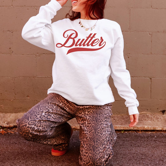 White butter script sweatshirt styled with cozy outfit aesthetic. Minimal yet bold graphic crewneck for butter lovers and farmhouse style fashion. Comfortable unisex sweatshirt with relaxed fit.
