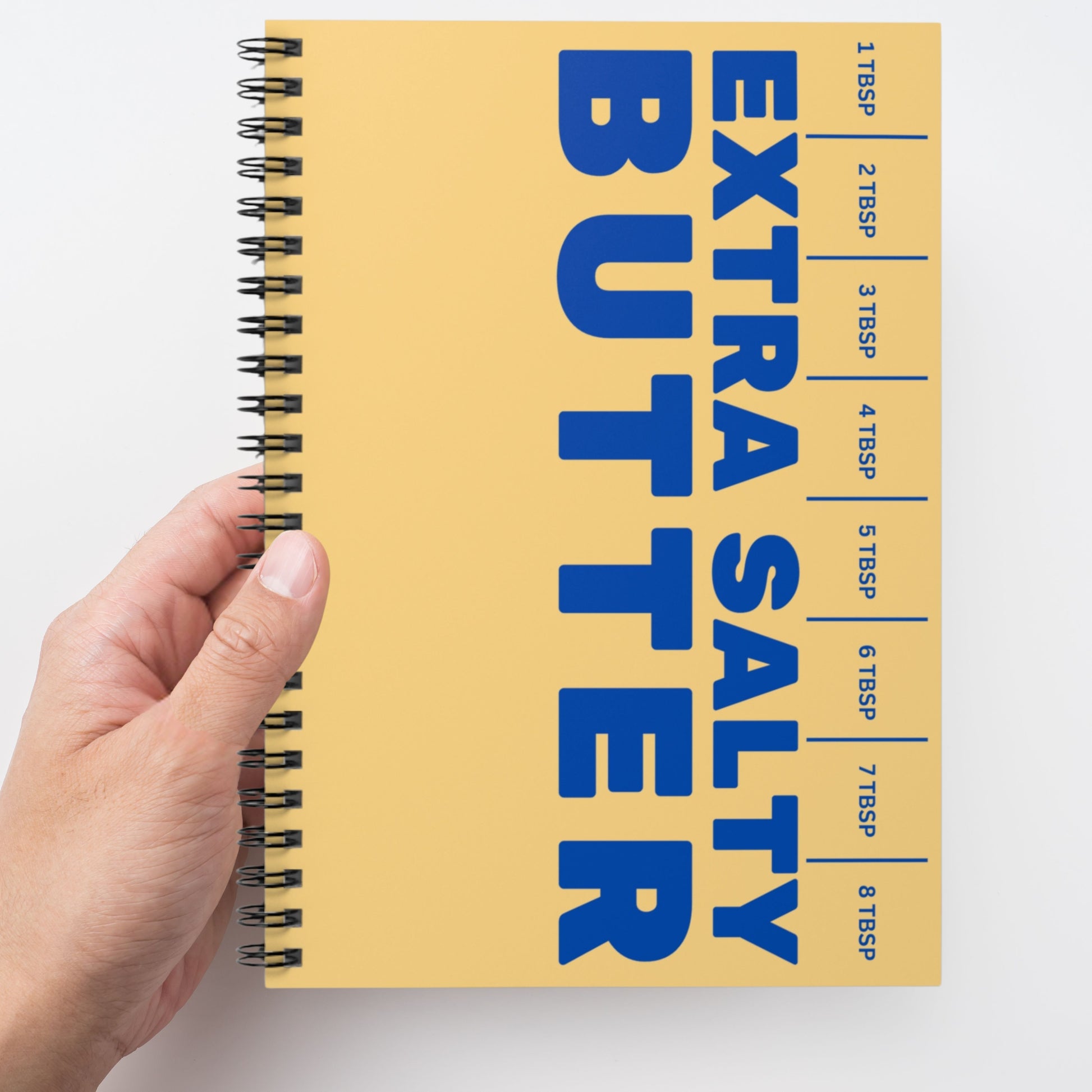Butter spiral notebook held in hand showing bold graphic cover. Fun and functional journal for everyday writing, planning, and note taking.