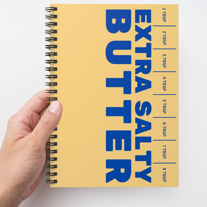 Butter spiral notebook held in hand showing bold graphic cover. Fun and functional journal for everyday writing, planning, and note taking.
