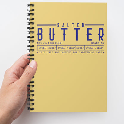 Butter spiral notebook held in hand showing bold yellow cover design. Functional journal for writing, organizing, and daily use.