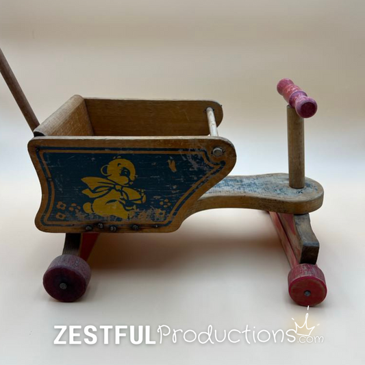 Blue bear illustration on side of vintage Cass Toys wooden doll cart