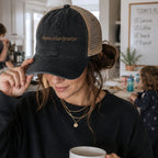 Woman wearing chaos coordinator embroidered trucker hat in a busy everyday lifestyle setting