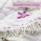 Beautiful corner detail of a vintage white chenille bedspread featuring decorative fringe, lavender floral accents, and raised chenille texture. This heirloom textile brings timeless cottage charm to farmhouse decor, shabby chic bedrooms, and romantic home interiors.