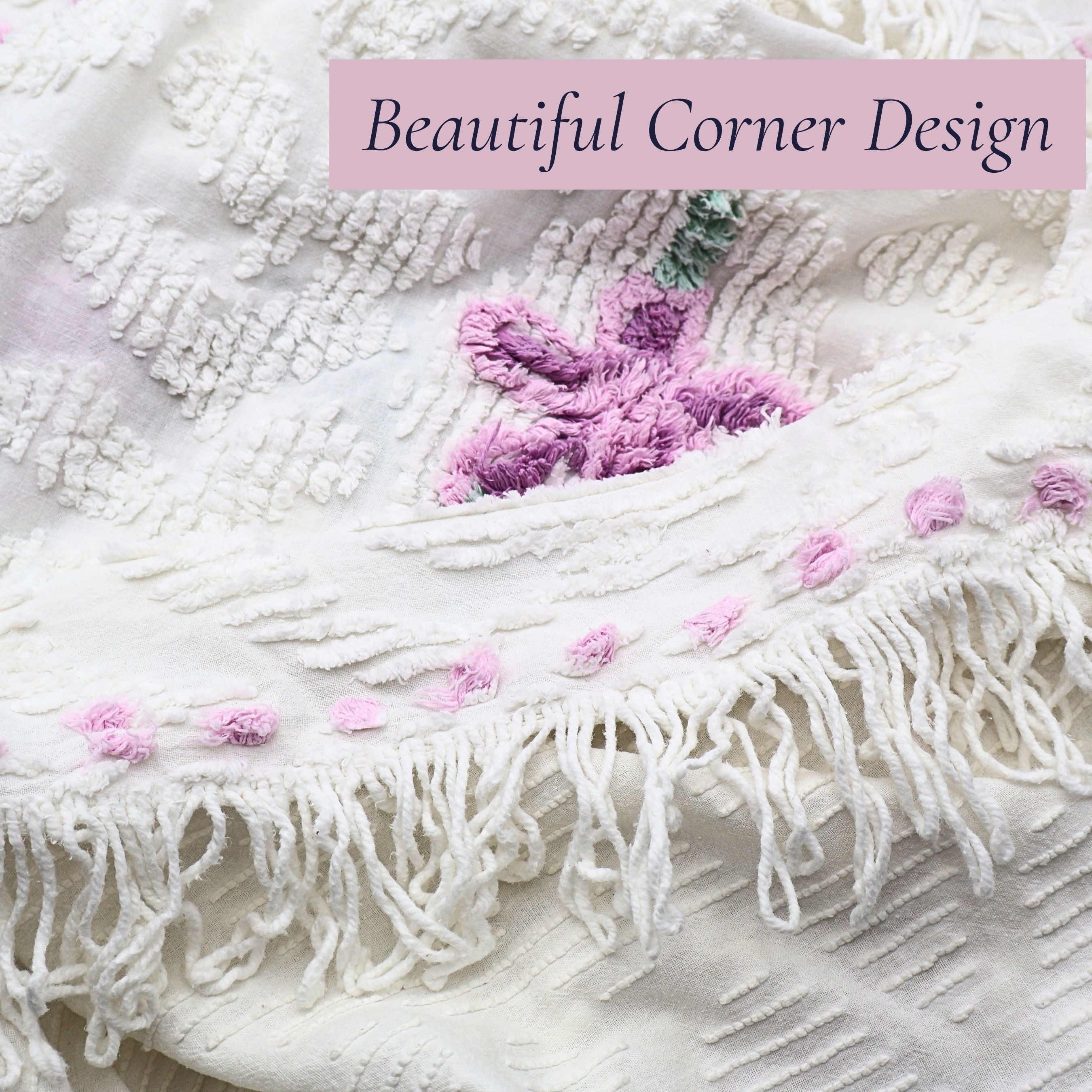 Beautiful corner detail of a vintage white chenille bedspread featuring decorative fringe, lavender floral accents, and raised chenille texture. This heirloom textile brings timeless cottage charm to farmhouse decor, shabby chic bedrooms, and romantic home interiors.