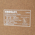 Back label of Crosley CR-9 jukebox radio showing model specifications, AM FM frequency range and cassette player details, vintage retro audio system with collector information