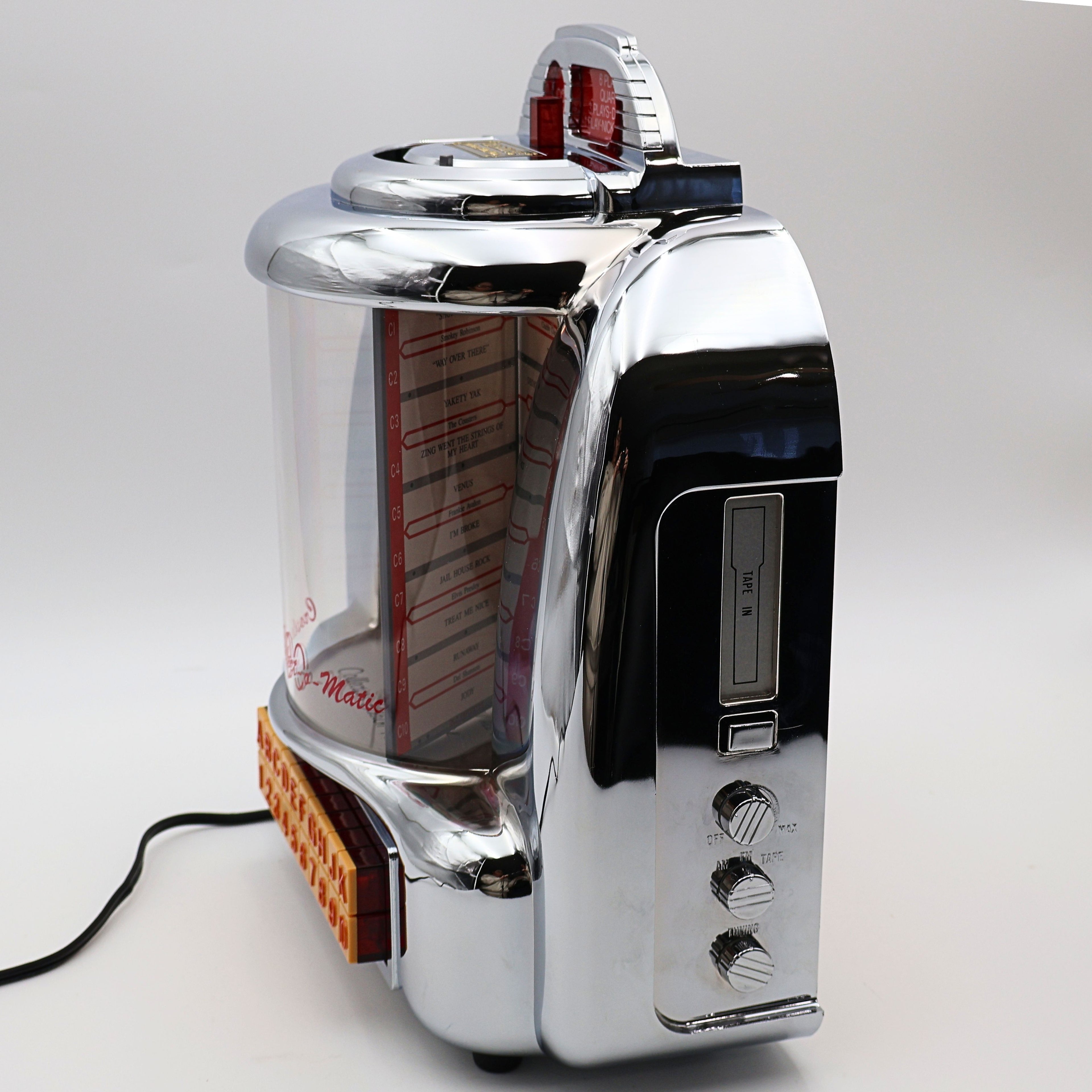 Angled side view of Crosley CR-9 jukebox radio showing cassette player, controls and curved chrome body, vintage 1950s diner style music player for nostalgic home decor