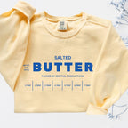 Folded personalized butter sweatshirt showing clean butter label graphic. Customizable cozy crewneck in soft garment dyed fabric.