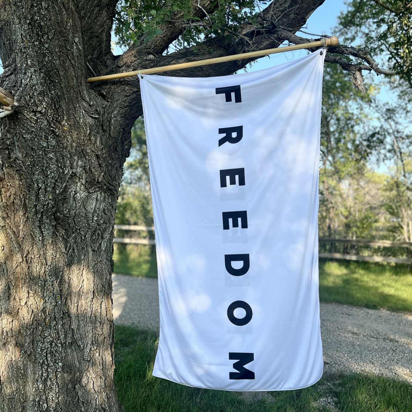 Large black and white Freedom flag banner hanging outdoors