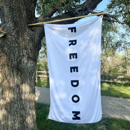 Large black and white Freedom flag banner hanging outdoors