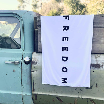Small black and white Freedom flag banner hanging outdoors
