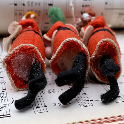 Underside view of German Belsnickle Santa ornaments showing feet and construction details