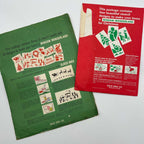 Reverse sides of green and red vintage Glass Wax Christmas stencil packages, showing illustrated decorating instructions, holiday design examples, and Gold Seal Company Bismarck labels. Creases, worn edges, and paper loss are visible on the original envelopes.