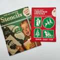 Two vintage Gold Seal Glass Wax Christmas stencil packages on a white surface. The larger green envelope shows a girl decorating a window with a Santa stencil; the red envelope displays angel, reindeer, tree, and sleigh designs with original printed prices.
