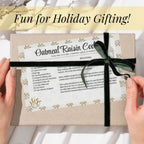 Golden Wheat recipe card tied to a wrapped gift with black ribbon and held in two hands. The vintage-inspired printable turns a favorite family recipe into a thoughtful holiday keepsake, hostess present or addition to a kitchen gift basket.