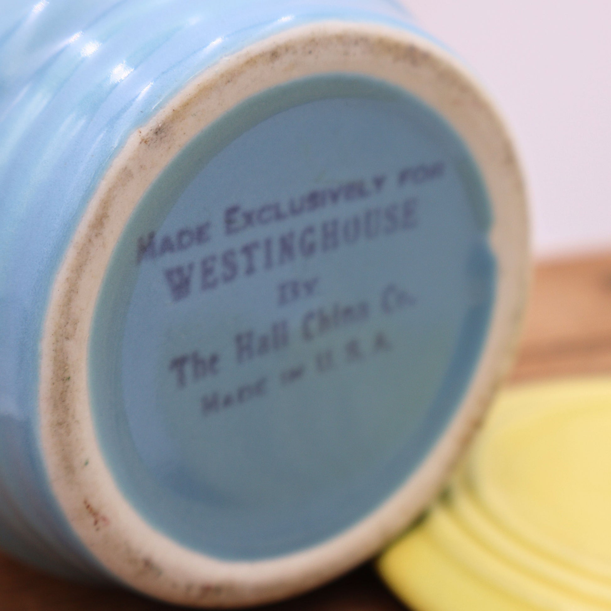 Close-up of vintage Hall China Westinghouse stamp on blue glazed base, Made in USA marking detail.