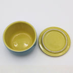 Top view of Hall China refrigerator crock showing butter yellow interior and matching yellow lid with concentric ring detail.