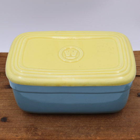 1950s Hall China refrigerator dish made for Westinghouse with original yellow lid and blue exterior.